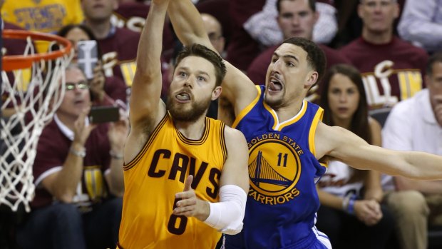 Cavalier crusade: Cleveland guard Matthew Dellavedova shoots in front of Golden State Warriors opponent Klay Thompson.