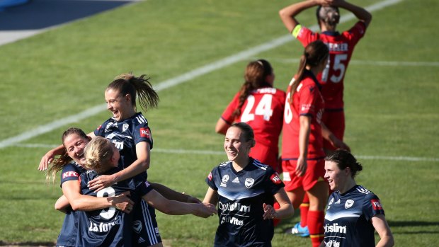 On a high: Natash Dowie is embraced by her Victory teammates after becoming the club's all-time leading W-League goalscorer.