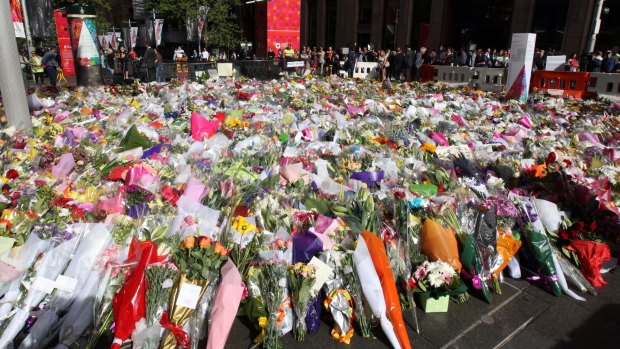Sea of flowers: The memorial to the victims of the Lindt Chocolat Cafe siege continued to expand in Martin Place on Wednesday.