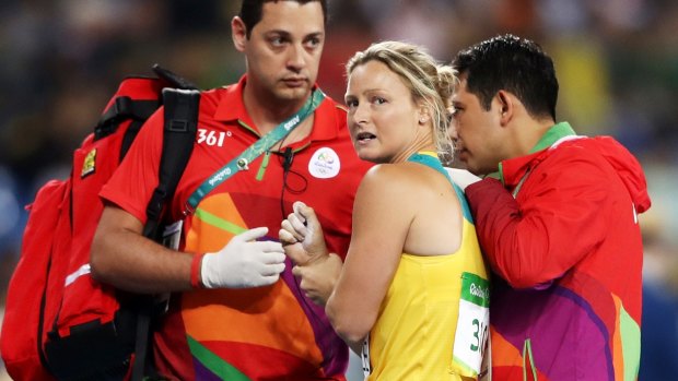 Mickle is assisted by medical staff after dislocating her shoulder at the Rio Olympics.