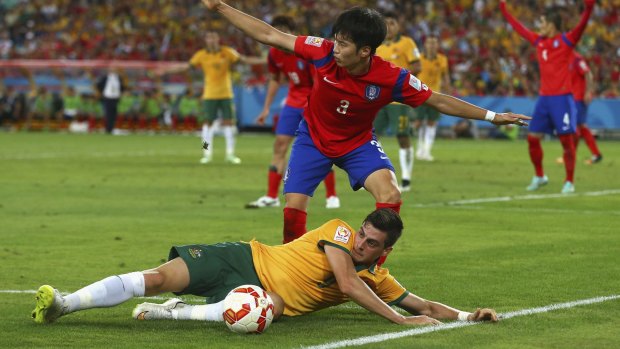 Fouled but not beaten: Tomi Juric of Australia moments before setting up the winning goal.