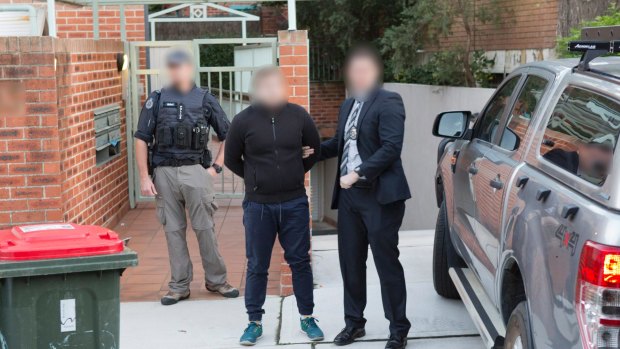 AFP handout photo showing the arrest of Adam Cranston outside his Bondi home.