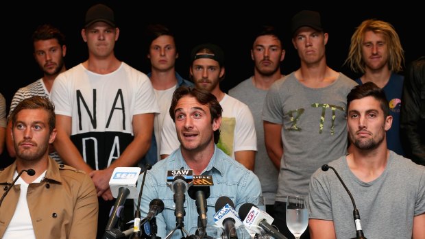 Jobe Watson, flanked by teammates, fronts the media.