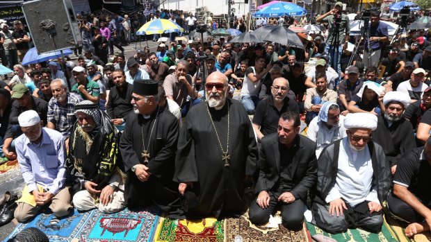 Christians, Sunnis and Shiites pray together at the scene of the attack.