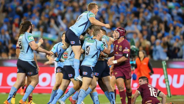 MELBOURNE, AUSTRALIA - JUNE 17: Josh Dugan of the Blues is congratulated by team mates after scoring a try during game two of the State of Origin series between the New South Wales Blues and the Queensland Maroons.
