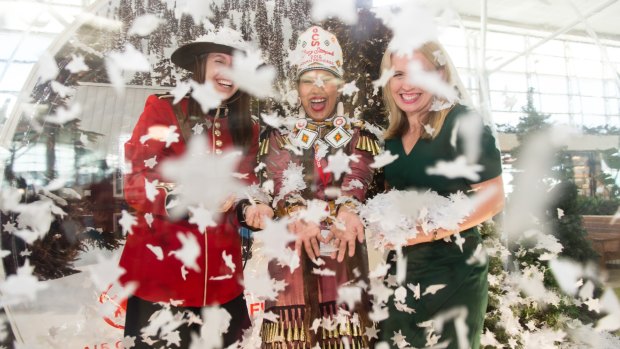 A Canadian Mountie, the First Nation Calgary Princess and Tourism Minister Kate Jones inside the giant snow dome at Brisbane International Airport.