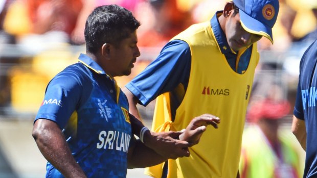 Rangana Herath walks off after injuring his hand against England.