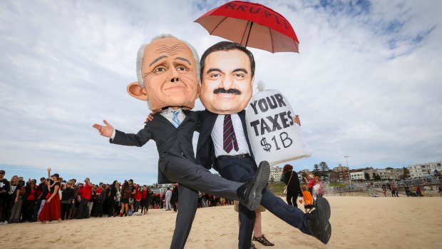 Two protestors wear masks depicting Malcolm Turnbull and Adani founder Gautam Adani. Photo: Katherine Griffiths