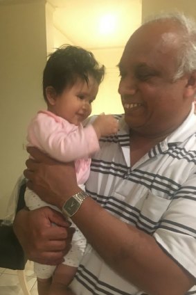 Ranjith Peiris with his one-year-old granddaughter.