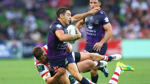 Well held: Billy Slater is tackled by Gareth Widdop and Will Matthews.