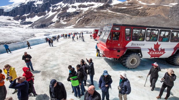 Crowds surround an Ice Explorer on Athabasca Glacier.