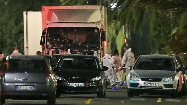 Police surround the truck that slammed into a Bastille Day crowd in Nice on Thursday.