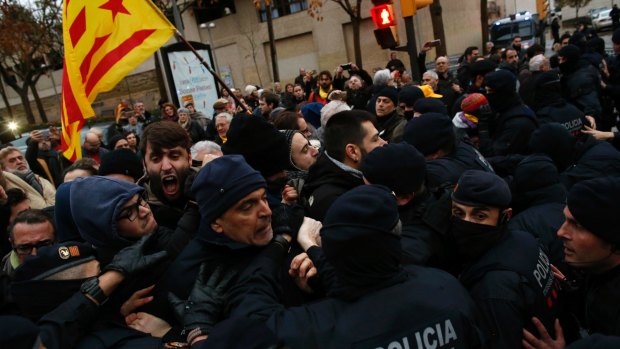 Catalan Mossos d'Esquadra officers scuffle with demonstrators as they cordon off the area around Lleida museum in the west of Catalonia, Spain.