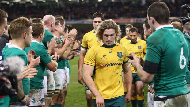 Aussies beaten: Michael Hooper leads the Wallabies off the field after their loss to Ireland in Dublin.