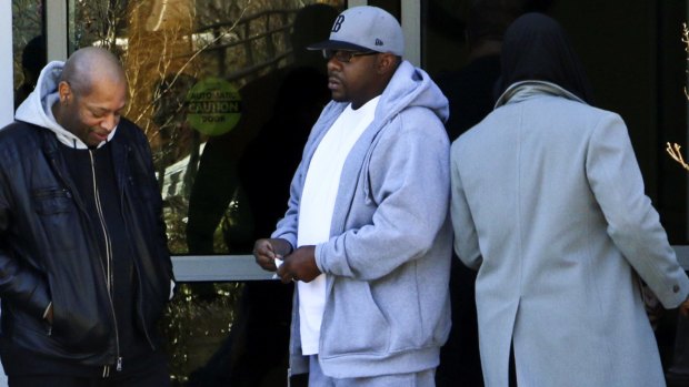 Bobby Brown, center, stands outside of Emory Hospital in Atlanta where his daughter Bobbi Kristina Brown is being treated on February 5, 2015.