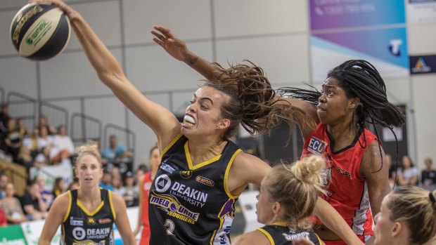 Boomer Louella Tomlinson controls a rebound in front of Perth's Amanda Dowe during their WNBL semi-final clash on Wednesday night.