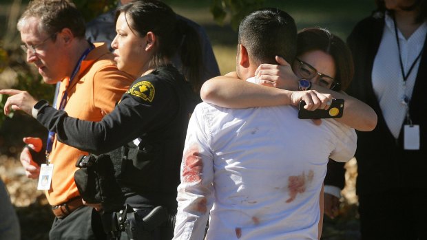 A couple embraces following the shooting.