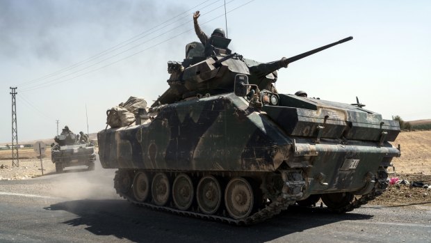 Turkish troops head to the Syrian border in Karkamis, Turkey.