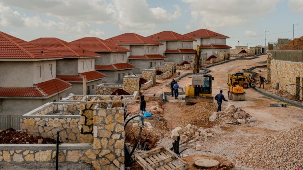 Palestinian laborers build a subdivision in Bruchin, an Israeli settlement in the West Bank that was retroactively legalised in 2015.