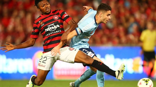 Battling hard: The Wanderers' Seyi Adeleke attempts to dispossess Sydney FC's Chris Naumoff.