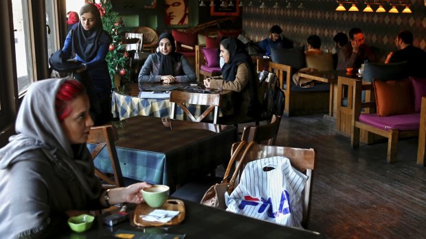 Young people spend their time at a cafe in downtown Tehran on Wednesday.