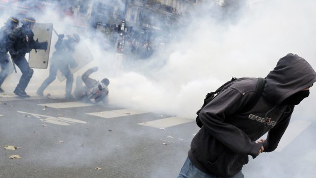 Policemen fight with activists ahead of the 2015 Paris Climate Conference at the place de la Republique, in Paris.