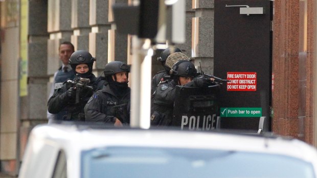 Heavily-armed police at a door of the Lindt Cafe during the siege on December 14.