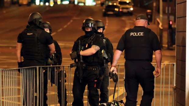Armed police work after an explosion at the Manchester Arena in Manchester, England.