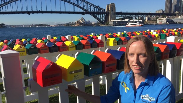 Erin Vassallo with the Fatality Free Friday letterboxes, each of which represents a death on NSW roads in 2016. Ms Vassallo's nephew died in a car crash in July 2014. 