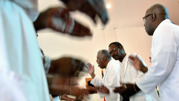 Pastor Jerry Colbert, 64, (centre), at the Hall United Methodist Church in Glen Burnie, Maryland.
