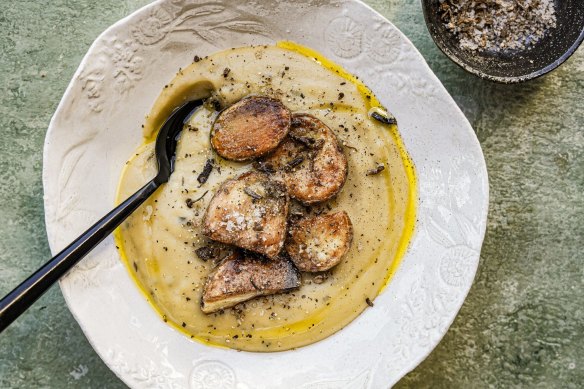 Carb on carb: Creamy potato soup topped with roasties and porcini salt.