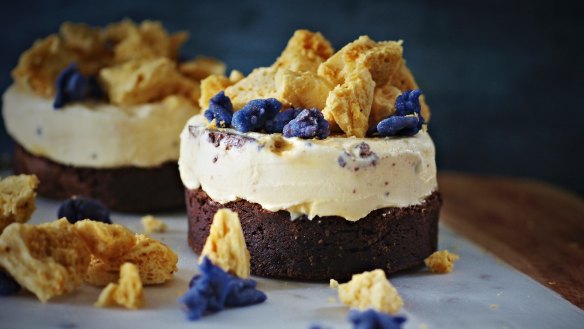 Violet Crumble-inspired ice-cream cake with brownie base, crystallised violets and honeycomb.