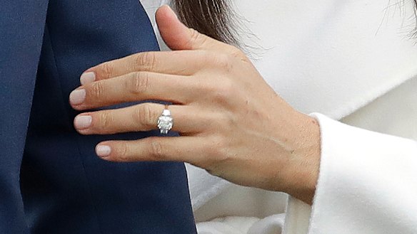 Britain's Prince Harry's fiancee Meghan Markle shows off her engagement ring.