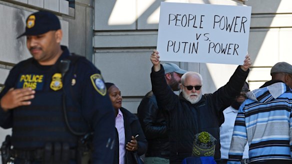 A protestor stands outside federal court as former Trump national security adviser Michael Flynn pleaded guilty.