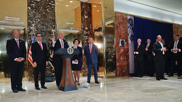 President Donald Trump speaks to the media in the lobby of Trump Tower.