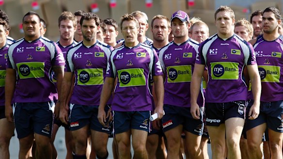 Purple pain: Storm players and coach Craig Bellamy make their defiant walk to waiting media after the scandal broke.