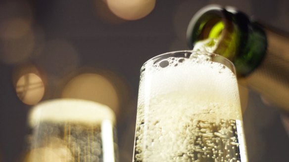 Sparkling wine being poured into glass. 