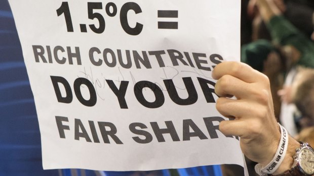 A poster demanding that warming be limited to 1.5 degrees, held up during a protest by activists at the Paris climate talks.
