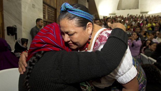 Rigoberta Menchu Tum, Nobel Laureate, right, embraces a victim of sexual violence moments after a judge read the guilty verdict for a former military officer and former paramilitary fighter for the sexual abuse of indigenous women.