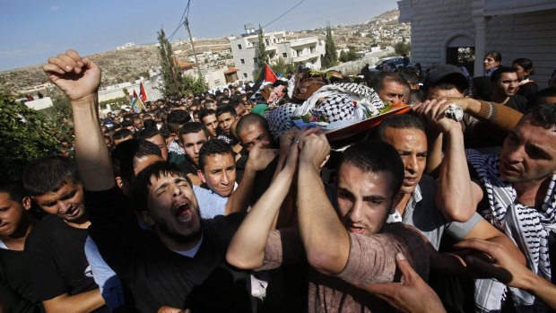 Palestinian mourners carry the body of 22 year-old Raed Jaradat during his funeral in the West Bank village of Sa'ir, near Hebron, on Sunday.