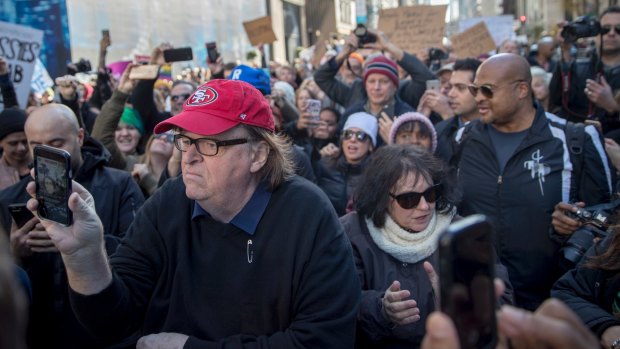 Filmmaker Michael Moore joins the demonstrators during a protest against the election of Donald Trump on Fifth Avenue near Trump Tower.
