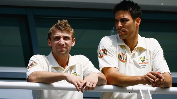 Mates: Hughes and Mitch Johnson look on from the balcony  during day one of the first Ashes Test in Cardiff in 2009.