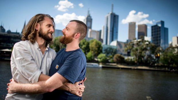Hoping for a 'yes': Engaged couple Sam Cremean, left, and Adam Seymour will picnic beside the Yarra to await the same sex marriage survey results.