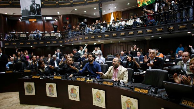 Opposition lawmakers shout, "Fraud, fraud" during a session of the Venezuelan National Assembly after learning that results of Venezuela's election on Sunday may be off by at least 1 million votes.