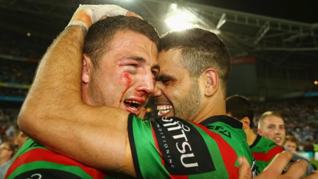 No time to celebrate: Sam Burgess with Greg Inglis after winning the 2014 NRL grand final. 