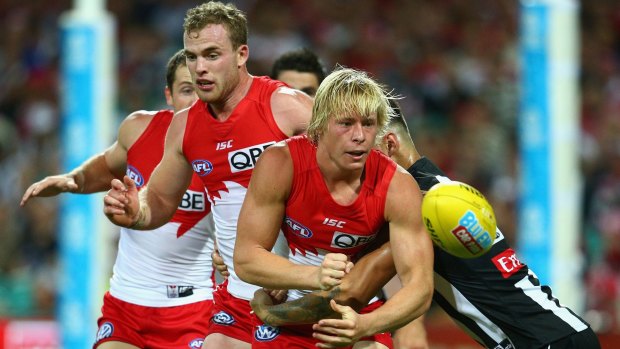 Setting it up: Isaac Heeney of the Swans handpasses to launch an attack.