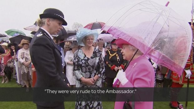 Queen Elizabeth II speaks with Metropolitan Police Commander Lucy D'Orsi in the garden of Buckingham Palace in London on Tuesday