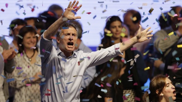 Top opposition presidential candidate and Buenos Aires Mayor Mauricio Macri dances and sings after speaking to supporters in Buenos Aires on Sunday.