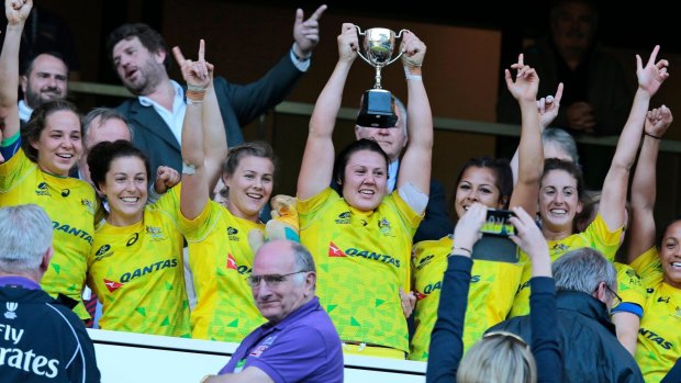 Triumphant: Australia women's sevens team hold aloft the trophy at Twickenham.