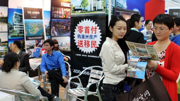 Investors crowd round an Australian booth at a property fair in Beijing.